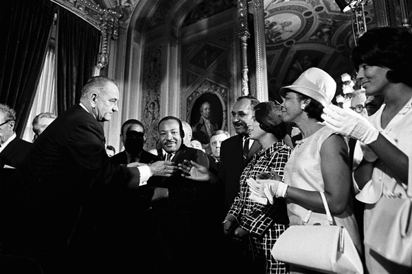 Penningroth said Black Americans navigated the law prior to the Civil Rights Movement. Black leaders in the 1960s, in turn, had faith in the rule of law and fought to reform it. This photo shows President Lyndon B. Johnson with Martin Luther King Jr. and other civil rights leaders after the Voting Rights Act of 1965 was signed. Ernest Withers via St. Lawrence University Art Gallery / Flickr