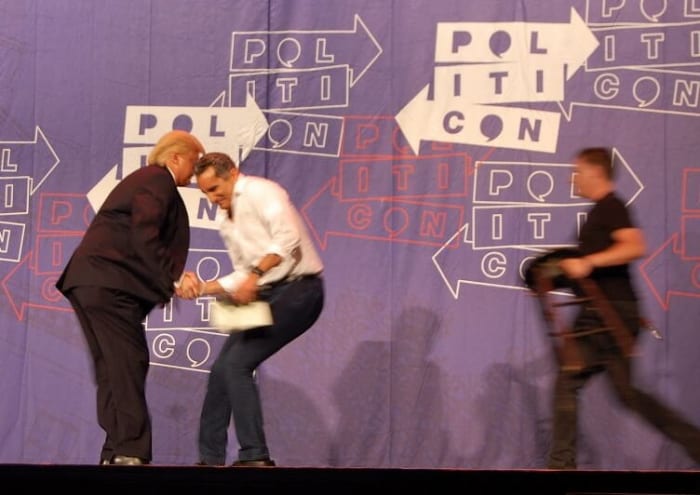 Trump impersonator Anthony Atamanuik of Comedy Central's "The President Show" with Bassem Yousseff, shaking hands/arm wrestling.
