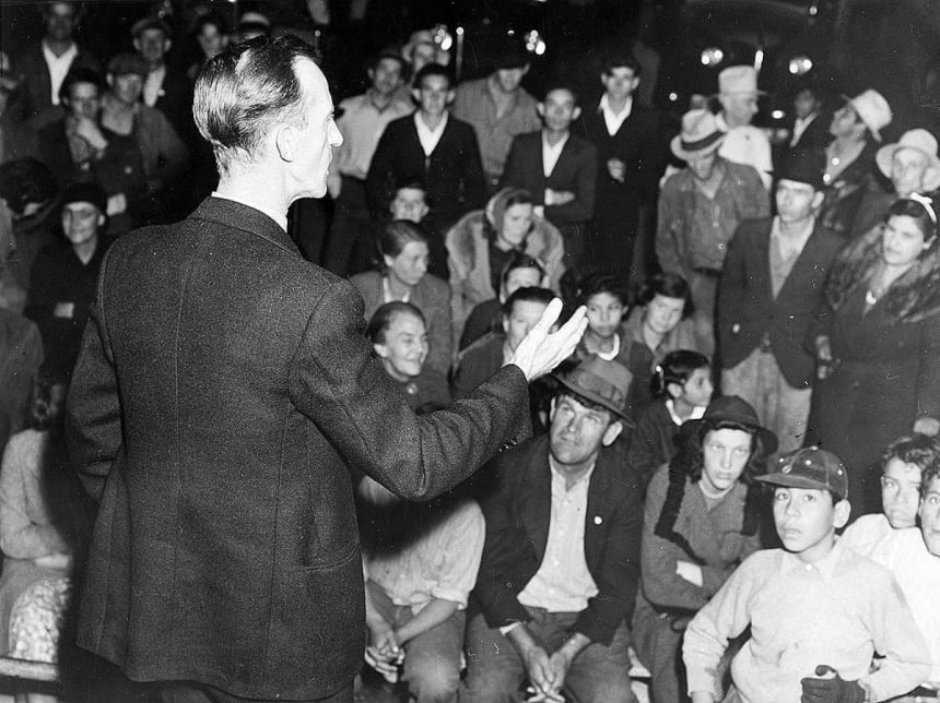 Organizer for the United Cannery Agricultural Packing and Allied Workers of America (CIO) Addresses Street Meeting of Striking Farmers, Mexican Town, outside Shafter, California; Dorothea Lange. This work is in the public domain in the United States because it is a work prepared by an officer or employee of the United States Government as part of that person’s official duties under the terms of Title 17, Chapter 1, Section 105 of the US Code. Wikimedia Commons.