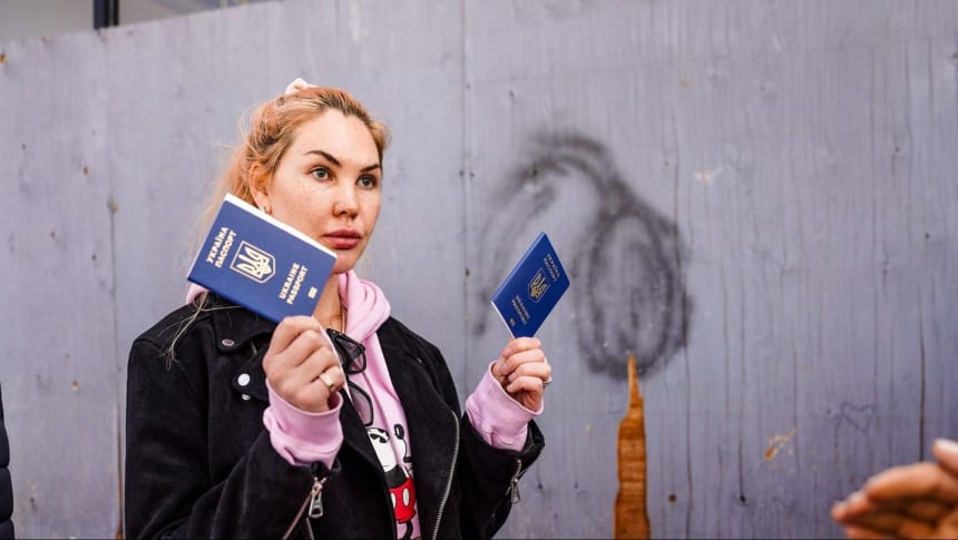 Maryna Sokolovska shows her family’s passports to Customs and Border Protection (CBP) officers at the San Ysidro port of entry at the U.S. Mexico border on March 14 2022. Photo by Manuel Ocaño for palabra.