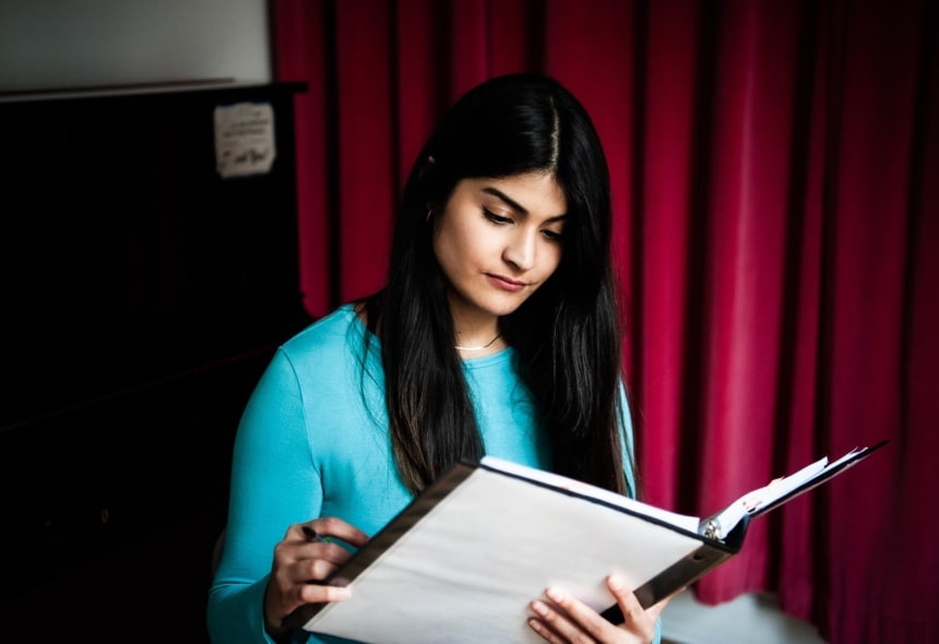 Lead actress and singer Legna Cedillo, who plays Ceci in the show, reviews the script during rehearsals. “I want for people to be seen and heard, and I think with this we have the opportunity to amplify voices,” said Cedillo. Photo by Mariela Murdocco for palabra
