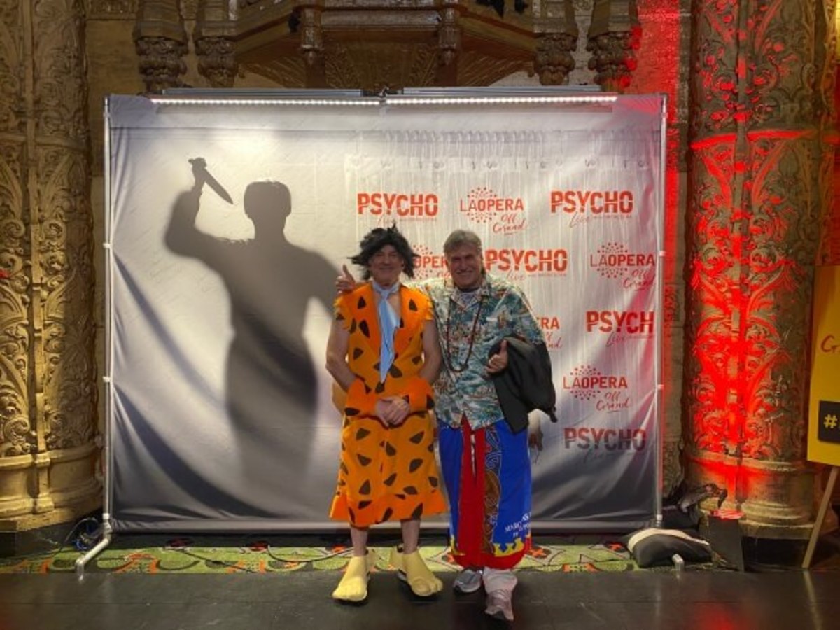 Childhood chums from New York's Forest Park Co-Op, Skip Sussman as Fred Flintstone and author Ed Rampell as a Polynesian, at the "Psycho" red carpet during the post-screening Halloween party in the lobby of the Theatre at the Ace Hotel. (Photo Credit: Norman Bates)