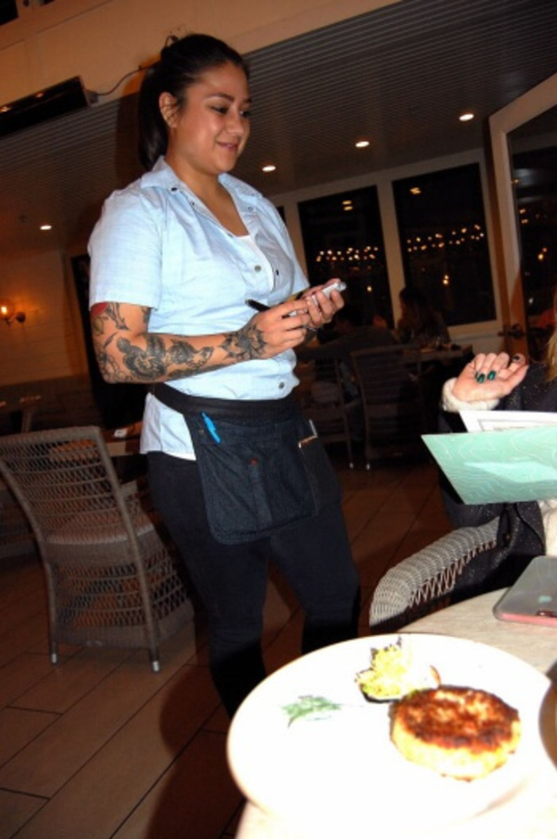 Festooned with tattoos, Sara dispenses culinary suggestions with attentive, friendly service that enhances feasts.