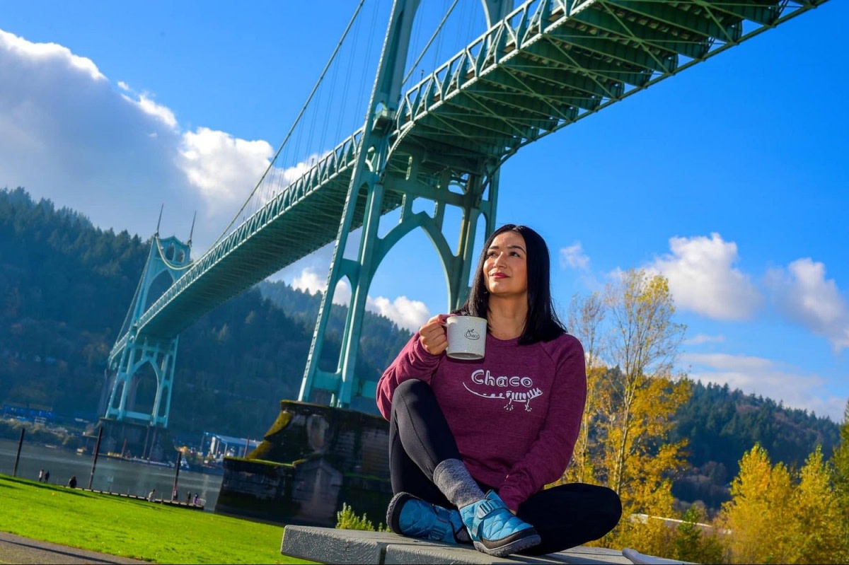 Maritza Oropeza Kritz, a volunteer leader and educator who works with Latino Outdoors in Portland, Ore. takes a break from her hike under the Saint Johns Bridge. Photo courtesy of Maritza Oropeza Kritz