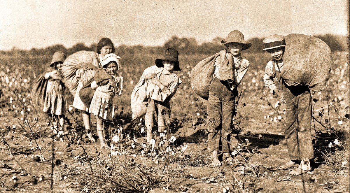Sharecropper children picking cotton.