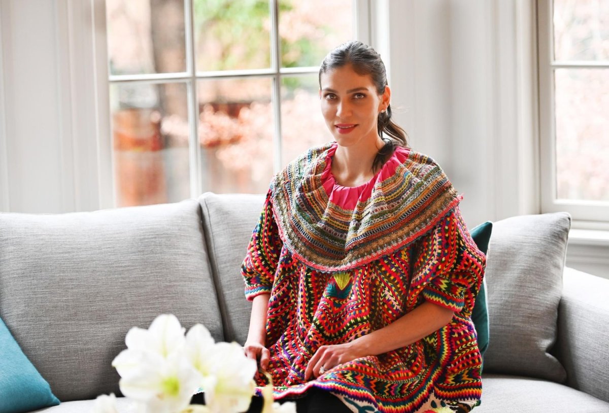 Fashion designer Alida Boer at home in Manhattan, wearing a handmade huipil. It is the most important garment of the Maya women, Boer explained. "Each design has different meanings: the snake with feathers, the power, the life, the fertility symbols.” Photo by Mariela Murdocco