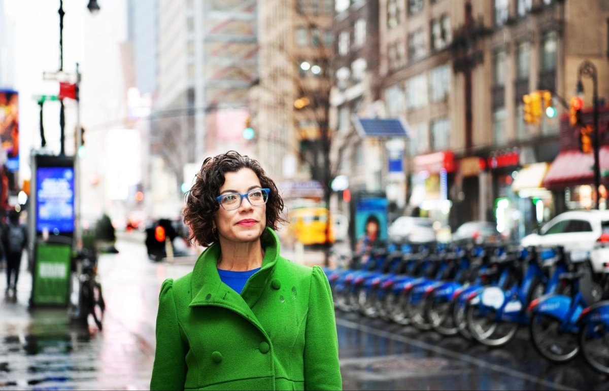 Fernanda Santos, pictured walking in New York City’s theater district, never imagined that her name would be on a billboard in Times Square. She moved to Boston from Brazil in 1998 to attend graduate school at Boston University. Her plan was to return to Brazil and get a job at a newspaper, but instead she stayed for an internship that changed the course of her life. Photo by Mariela Murdocco for palabra. 