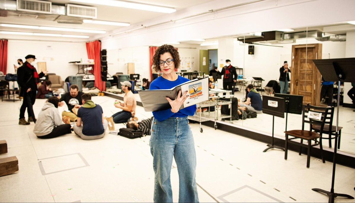 Award-winning journalist and author Fernanda Santos reviews the script she co-wrote for the musical ¡Americano! during rehearsals in New York City. Photo by Mariela Murdocco for palabra.